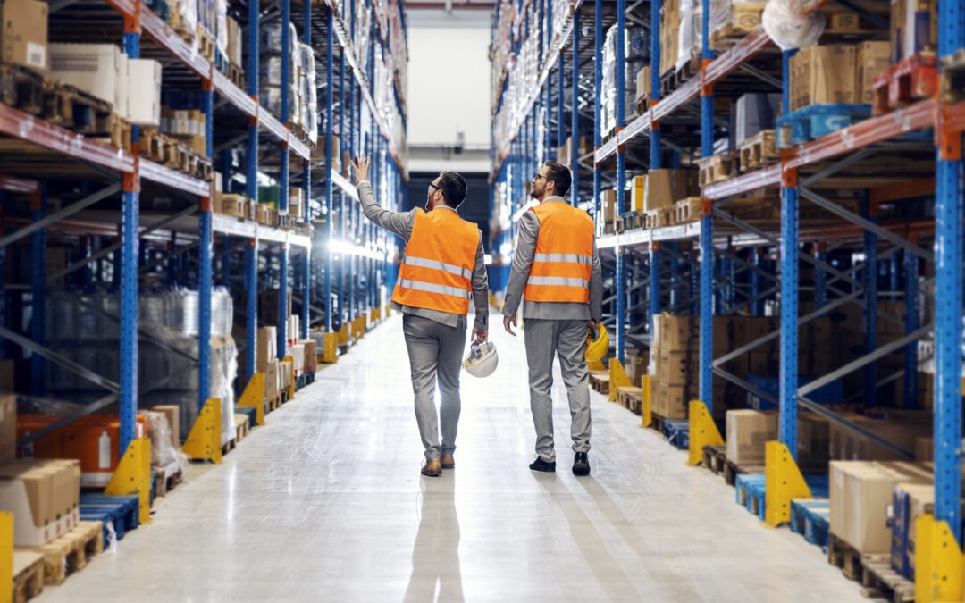 Two businessmen walking around storage.