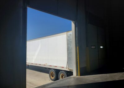 Elite Sourcing & Logistics docking bay ready for pallet delivery to warehouse with truck in next stall