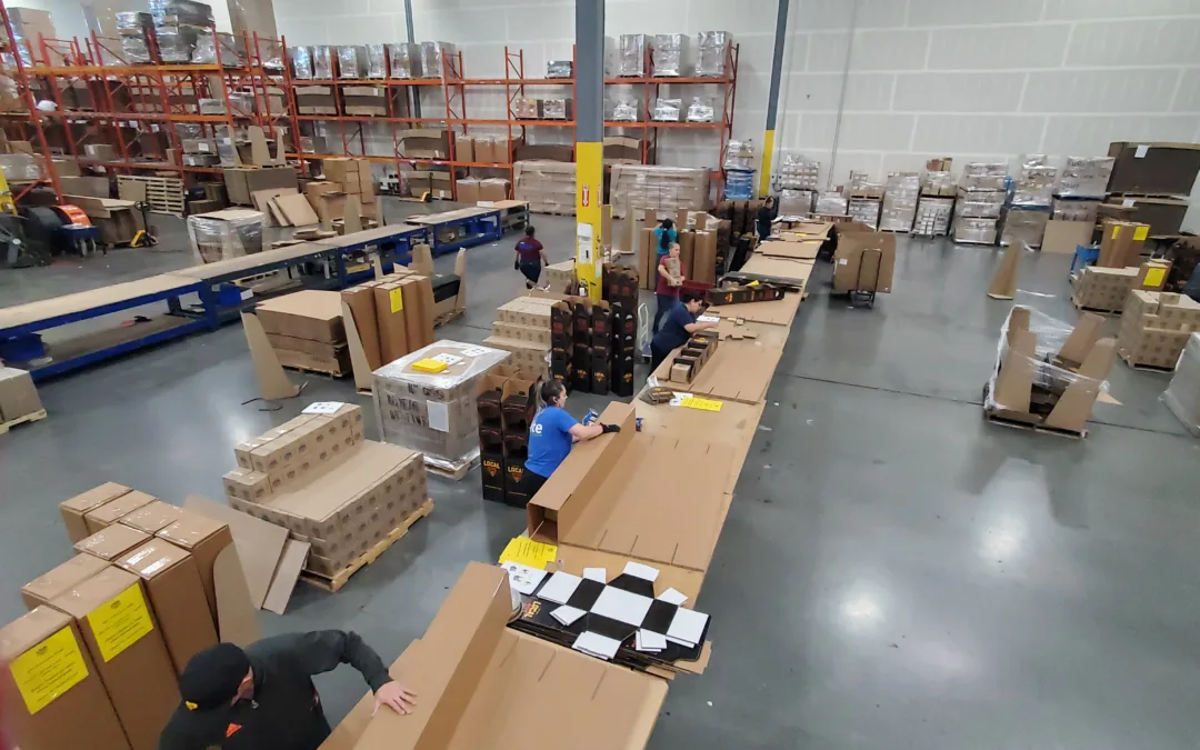 Elite Sourcing and Logistics team hand assembling product point of sale displays in warehouse