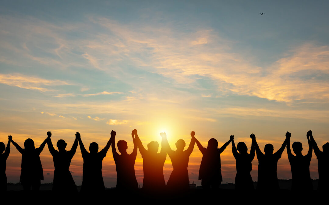 Silhouette of group business team making high hands over head in sunset sky evening time for business success and teamwork concept in company growth mergers and acquisitions start greeting etiquette